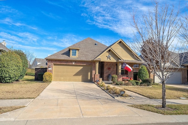 craftsman inspired home with a garage, driveway, brick siding, and a shingled roof