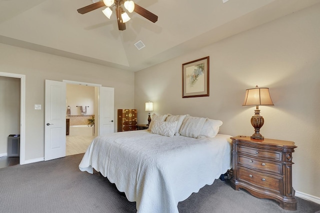 carpeted bedroom featuring visible vents, ensuite bathroom, a ceiling fan, vaulted ceiling, and baseboards