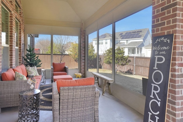 sunroom featuring vaulted ceiling