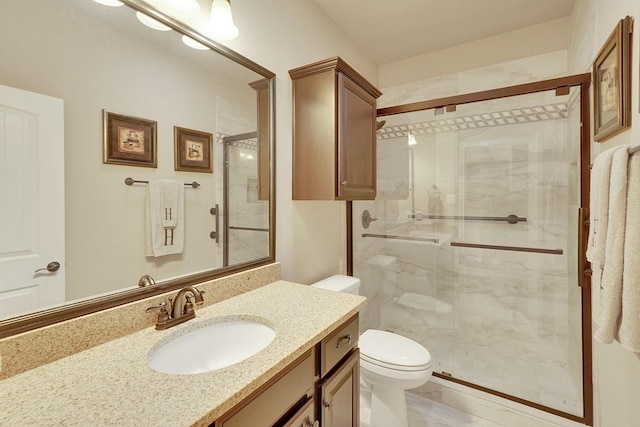 bathroom with toilet, a stall shower, and vanity