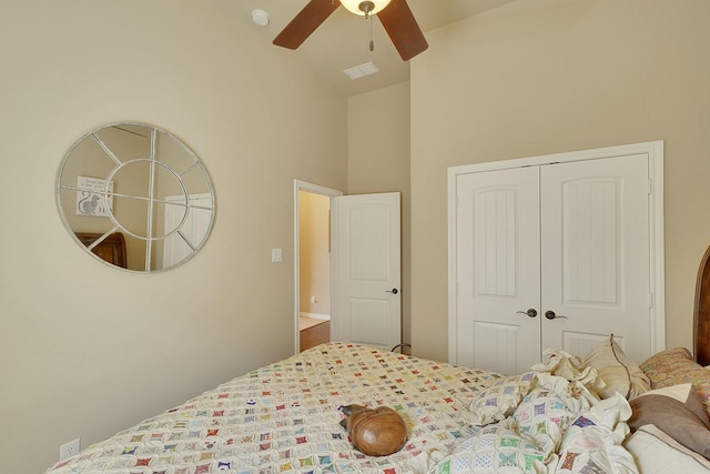 bedroom featuring high vaulted ceiling, ceiling fan, visible vents, and a closet