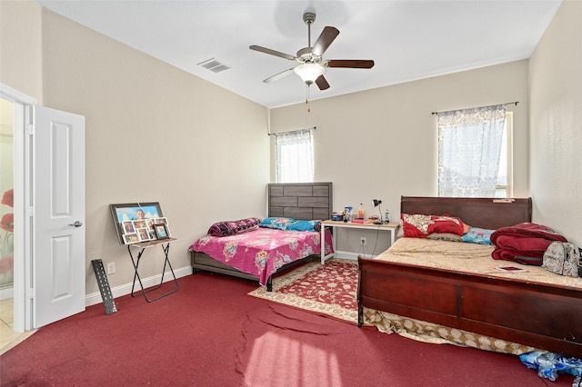 carpeted bedroom featuring baseboards, visible vents, and a ceiling fan