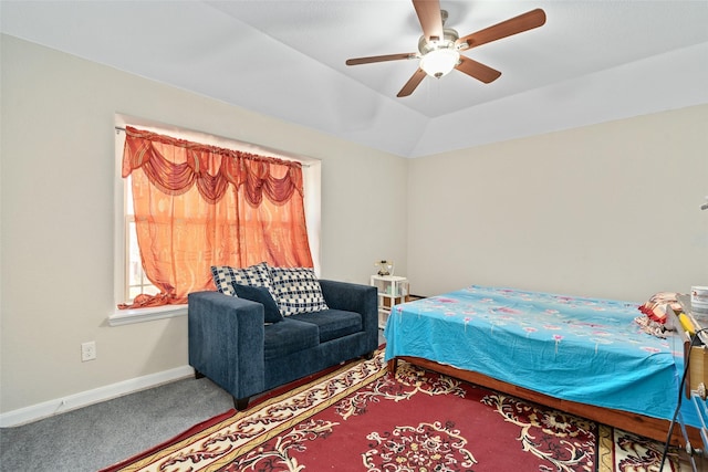 carpeted bedroom featuring vaulted ceiling, a ceiling fan, and baseboards