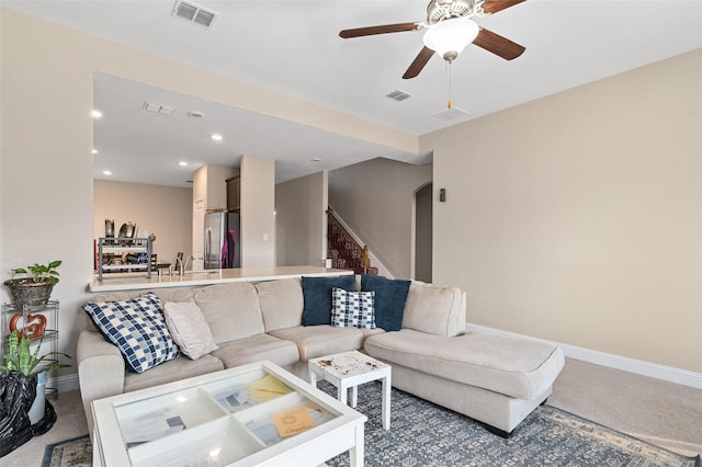 living room featuring arched walkways, carpet, and visible vents