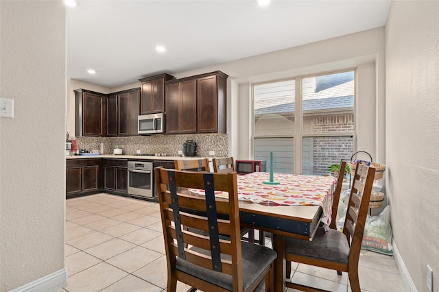 dining room with recessed lighting, a textured wall, baseboards, and light tile patterned floors