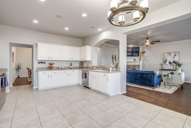 kitchen featuring dishwasher, light tile patterned floors, crown molding, white cabinetry, and ceiling fan with notable chandelier