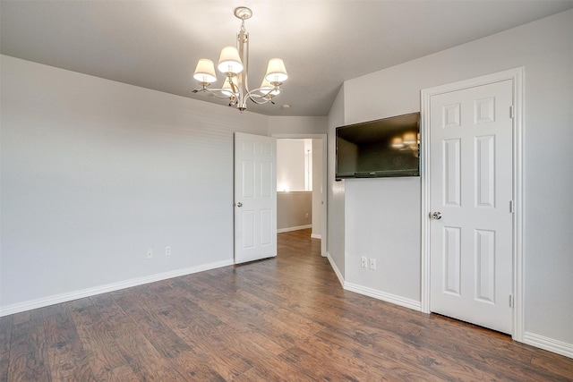 interior space with a notable chandelier and dark hardwood / wood-style floors