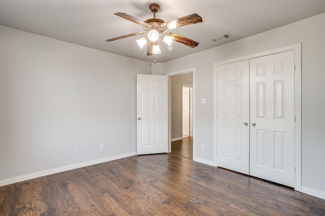 unfurnished bedroom featuring a closet, ceiling fan, and dark hardwood / wood-style floors