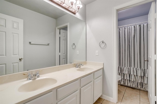 bathroom with toilet, tile patterned flooring, and vanity