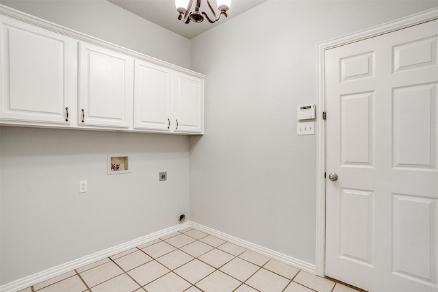 laundry room with a chandelier, light tile patterned floors, electric dryer hookup, cabinets, and washer hookup