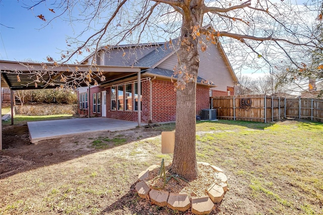 view of yard featuring central air condition unit and a patio area