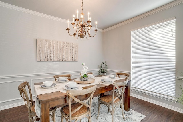 dining room with dark hardwood / wood-style flooring, a chandelier, and ornamental molding