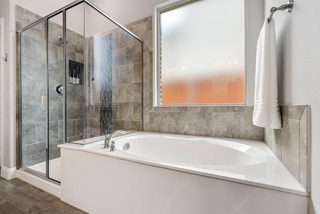 bathroom featuring hardwood / wood-style flooring and shower with separate bathtub