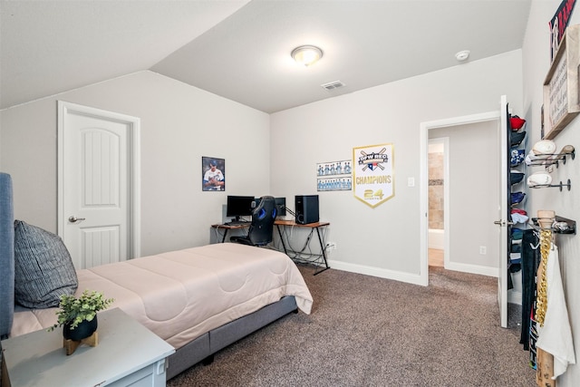 bedroom with vaulted ceiling and carpet