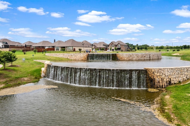 surrounding community featuring a yard and a water view