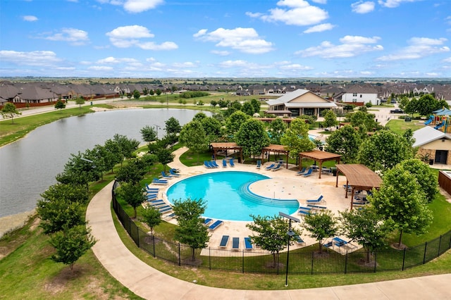 view of swimming pool with a patio area and a water view