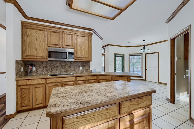 kitchen with light tile patterned flooring, a chandelier, tasteful backsplash, and kitchen peninsula