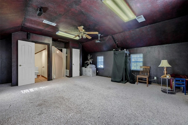 bonus room featuring ceiling fan, light carpet, and lofted ceiling