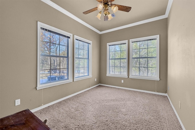 empty room featuring carpet floors, ceiling fan, and crown molding