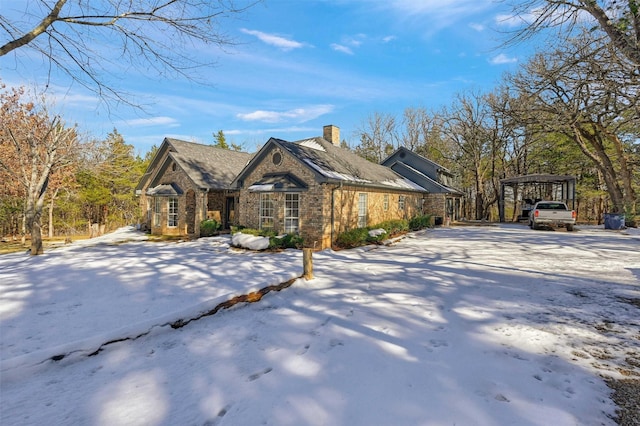 view of snowy exterior with a carport