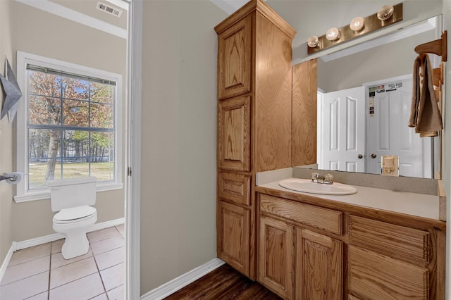 bathroom featuring toilet, vanity, and tile patterned floors