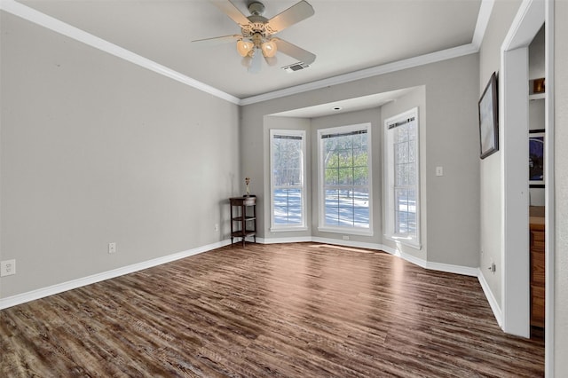 empty room with dark wood-type flooring, ceiling fan, and crown molding