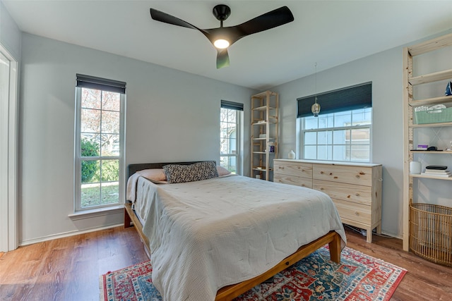 bedroom featuring wood-type flooring and ceiling fan