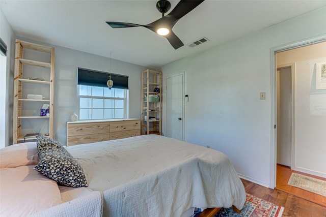 bedroom with hardwood / wood-style flooring and ceiling fan