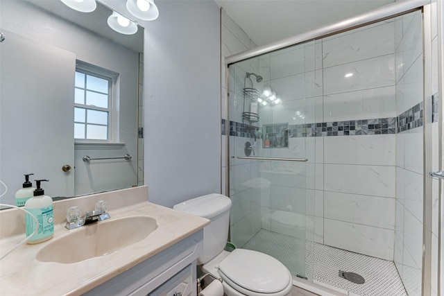 bathroom with walk in shower, vanity, and toilet