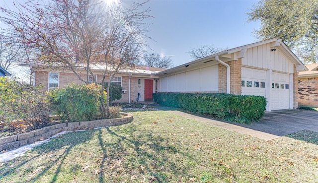 single story home featuring a garage and a front lawn