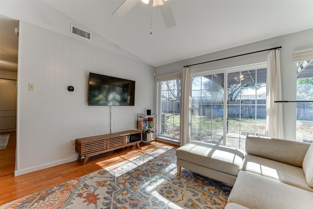 living room with vaulted ceiling, hardwood / wood-style floors, and ceiling fan