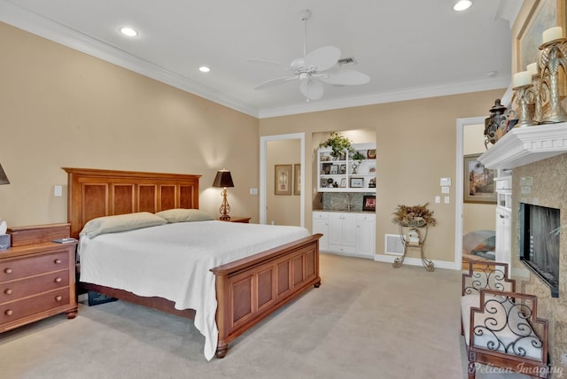 carpeted bedroom featuring a fireplace, ceiling fan, and ornamental molding