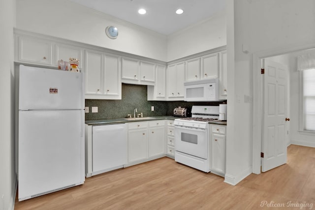 kitchen featuring sink, white cabinets, white appliances, tasteful backsplash, and light hardwood / wood-style floors