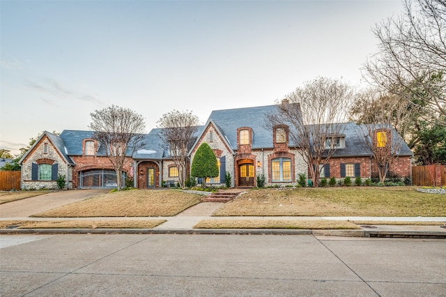 french provincial home featuring a front yard