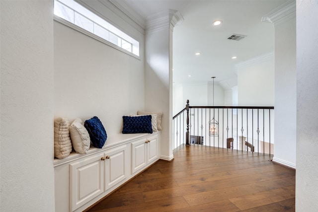 hall with dark wood-type flooring and crown molding