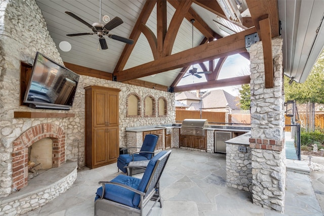 view of patio with ceiling fan, area for grilling, an outdoor stone fireplace, a gazebo, and grilling area