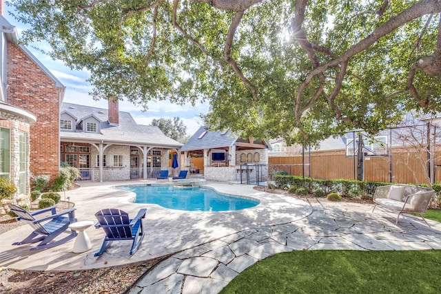 view of pool with exterior bar and a patio area