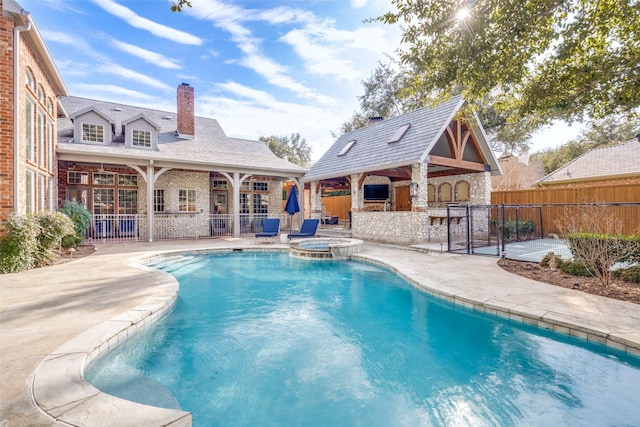 view of pool with a patio area and an in ground hot tub