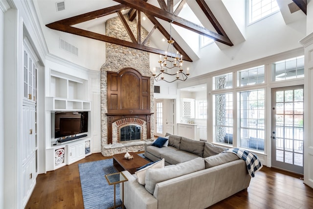 living room with beam ceiling, a stone fireplace, high vaulted ceiling, dark hardwood / wood-style flooring, and a chandelier