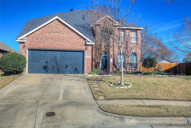 view of front property with a garage and a front yard