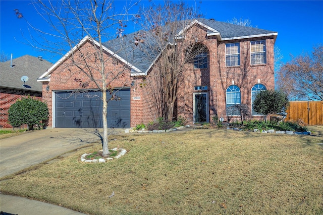 traditional-style home with a garage, driveway, brick siding, and a front lawn