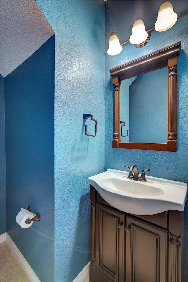 bathroom featuring tile patterned floors, vanity, and a textured ceiling