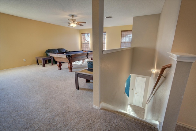 playroom with pool table, a textured ceiling, ceiling fan, and light carpet