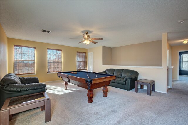 empty room with a textured ceiling, ceiling fan, and carpet flooring