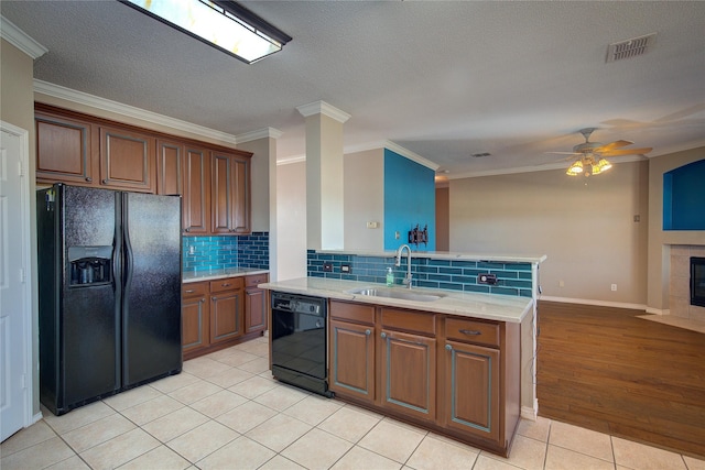 kitchen with sink, ceiling fan, light tile patterned floors, ornamental molding, and black appliances