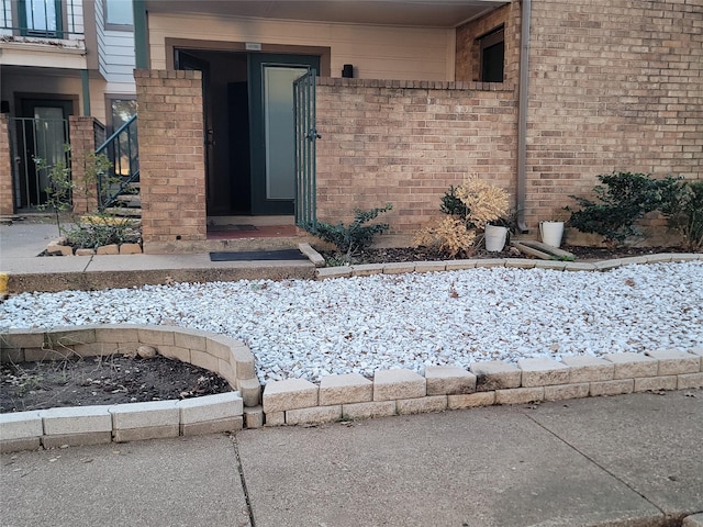 view of snow covered property entrance