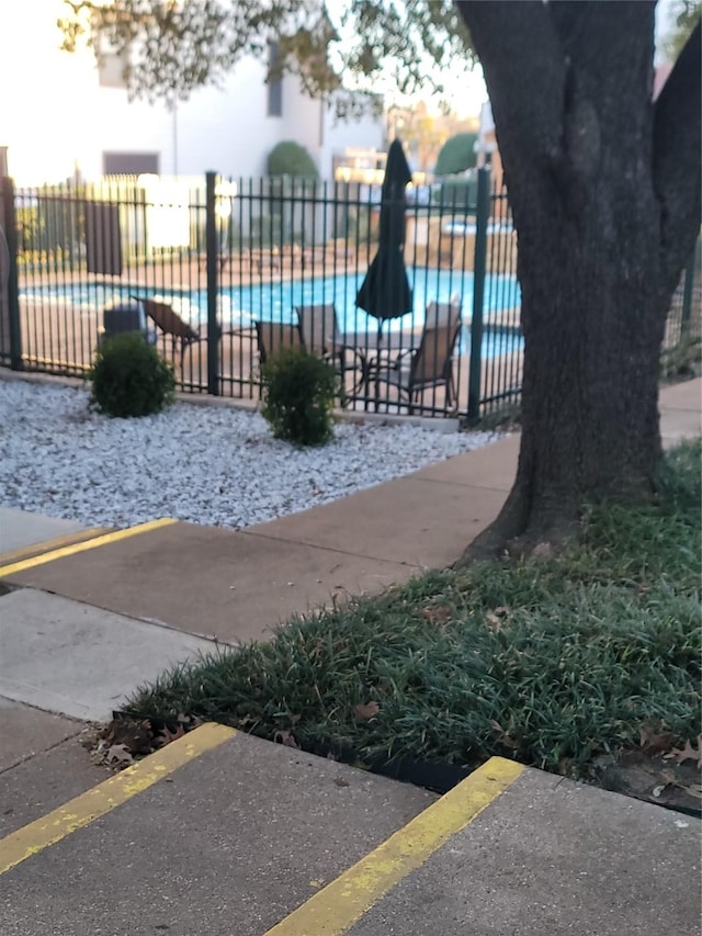 view of jungle gym with a fenced in pool and a patio