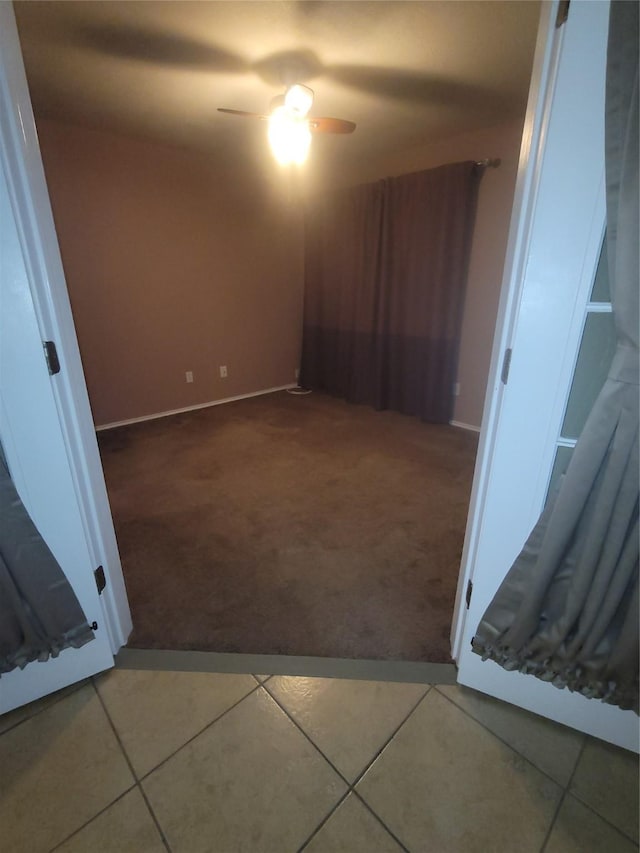 interior space featuring ceiling fan and tile patterned flooring