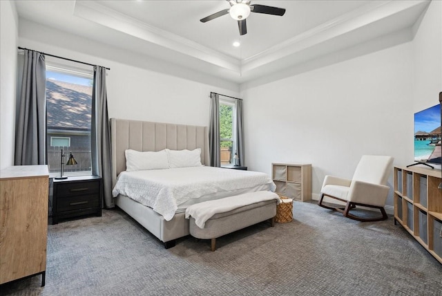 bedroom featuring ceiling fan, crown molding, and a raised ceiling