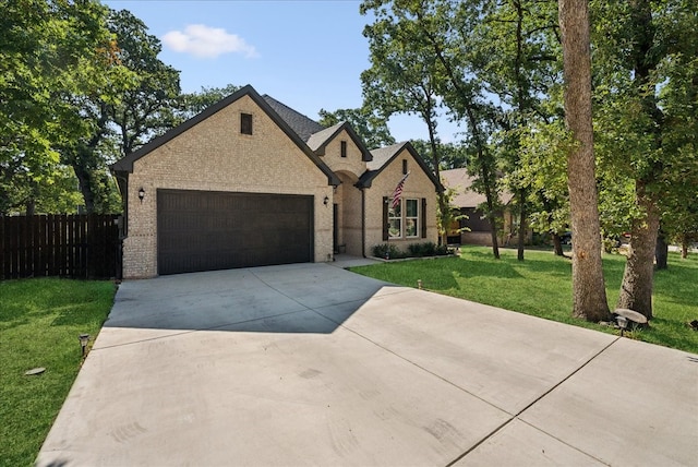 view of front of home featuring a garage and a front lawn